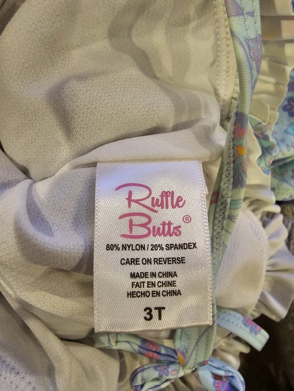Rufflebutt Toddler Girls' Floral Light Blue Ruffled One-Piece Swimsuit. Like New